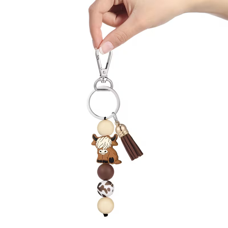 Highland Cow silicone beaded keyring with cow print bead and brown tassel by Woodland Beads & Co.