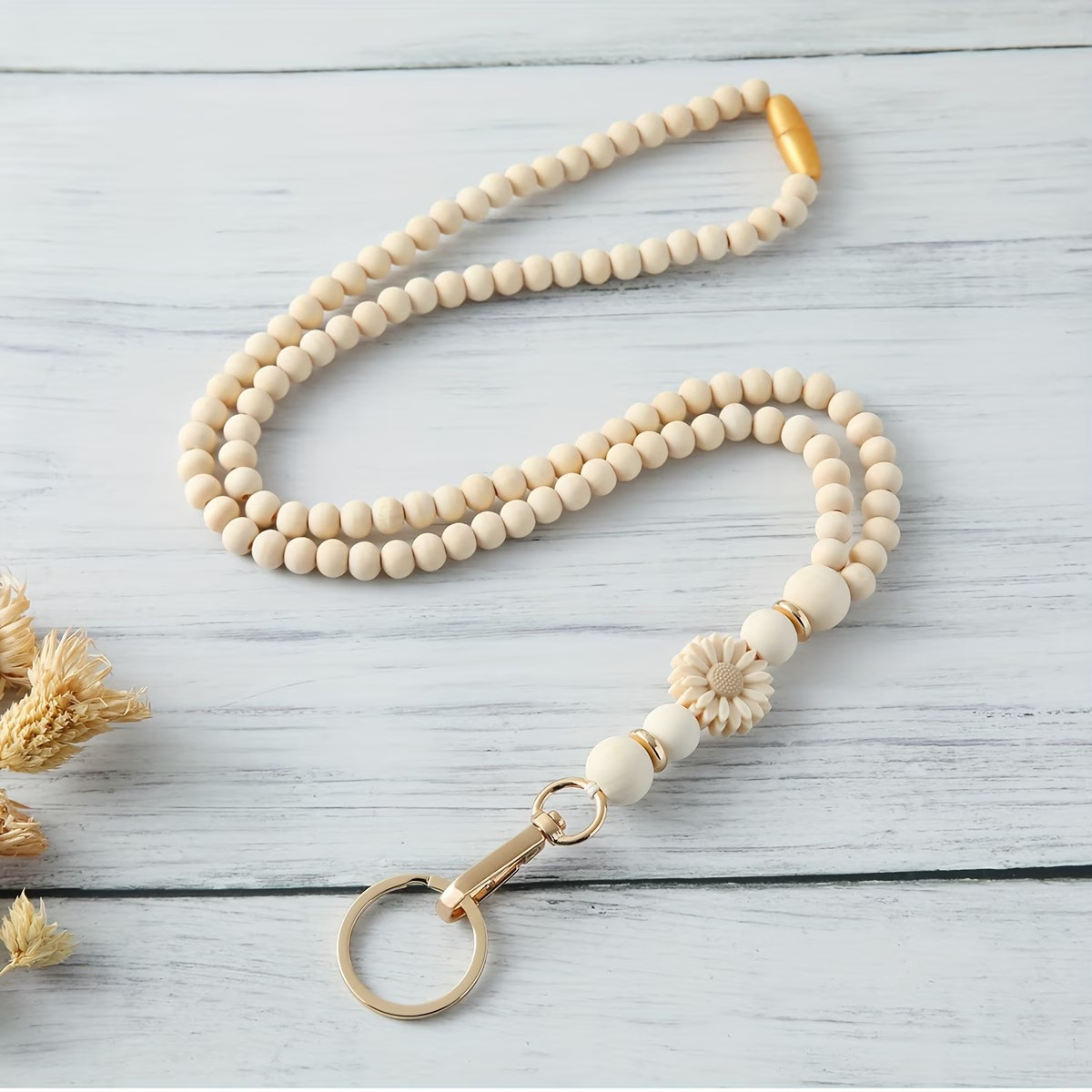Handcrafted beige daisy silicone beaded lanyard with gold accents and safety breakaway clasp by Woodland Beads & Co